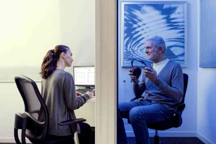 Audiologist performing hearing test