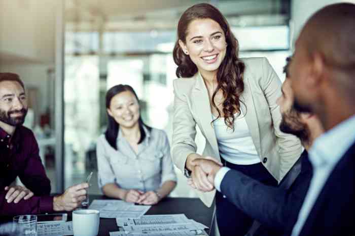 Office colleagues shaking hands during a meeting