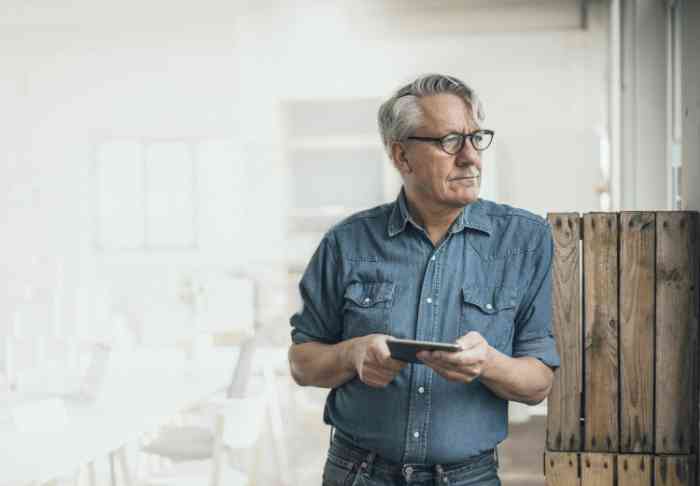 Man on his phone wearing glasses