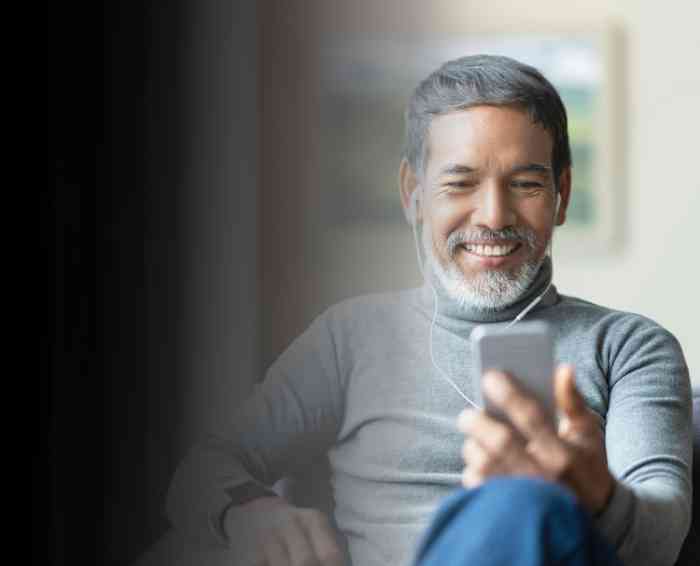 senior man on phone with Airpods