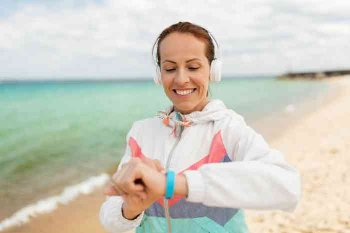 Woman on the beach checking her watch