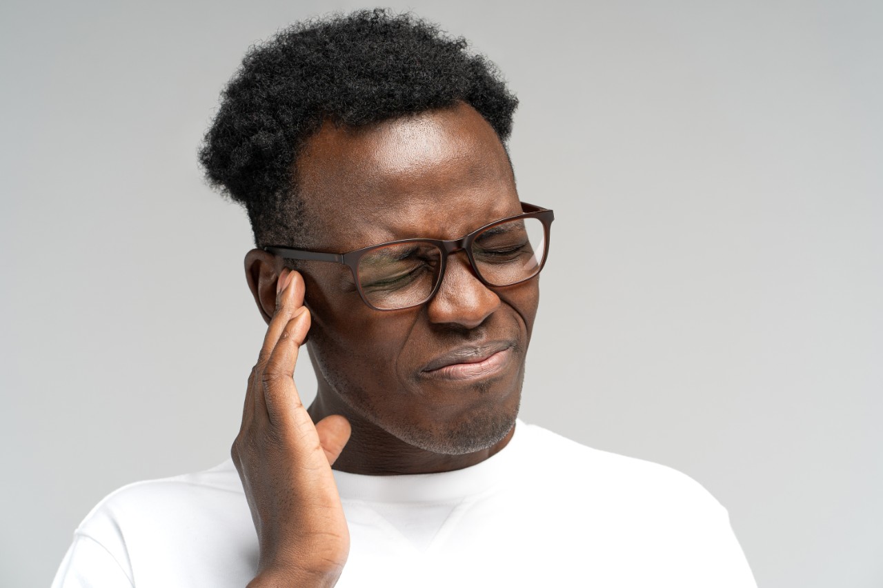 African American man suffering from ear pain