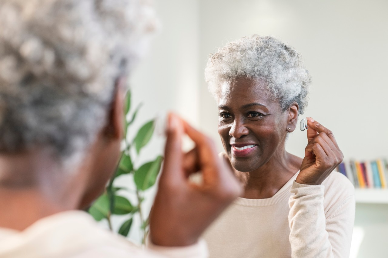 African American woman happy with hearing aid