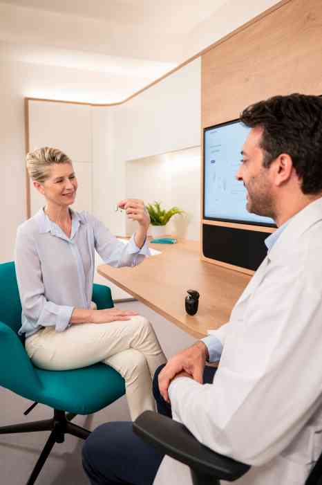 patient and audiologist inside store