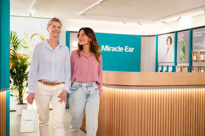 Two women walking out of store