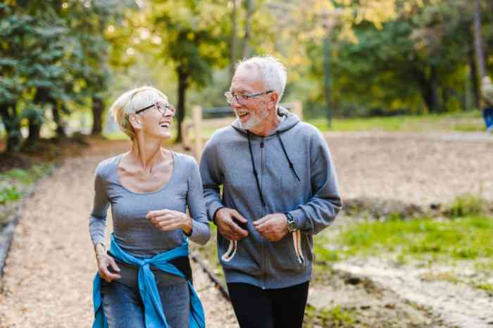Couple laughing and exercising together outdoors