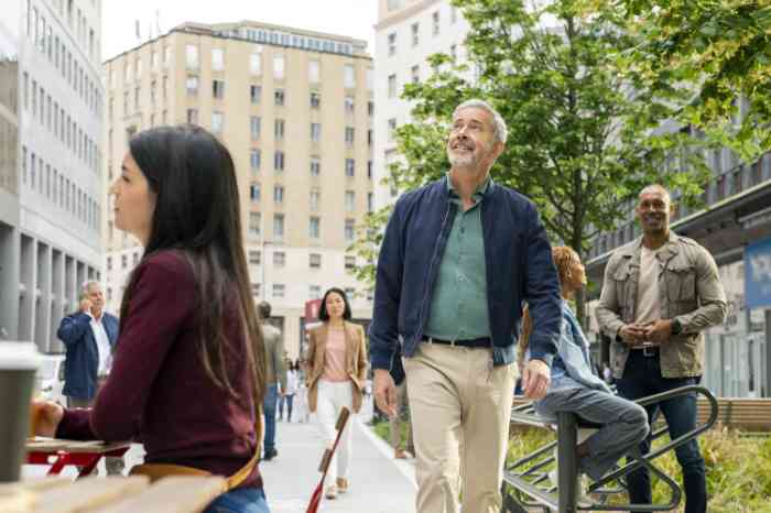man walking through city