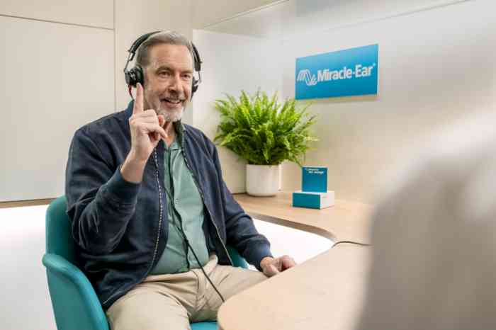 Smiling man having his hearing tested