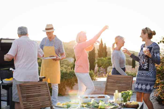 Man and woman laughing and dancing at an outdoor party
