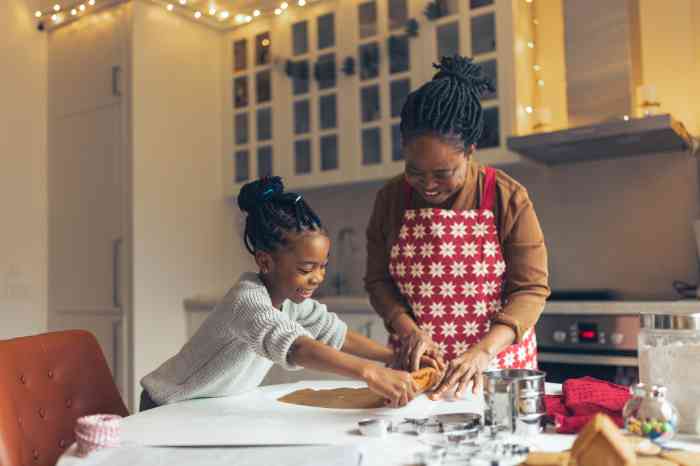 Grandmother and granddaughter baking holiday cookies