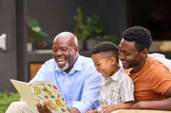 Three generations of male family members enjoying a book