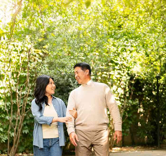 Woman and man walking together outdoors