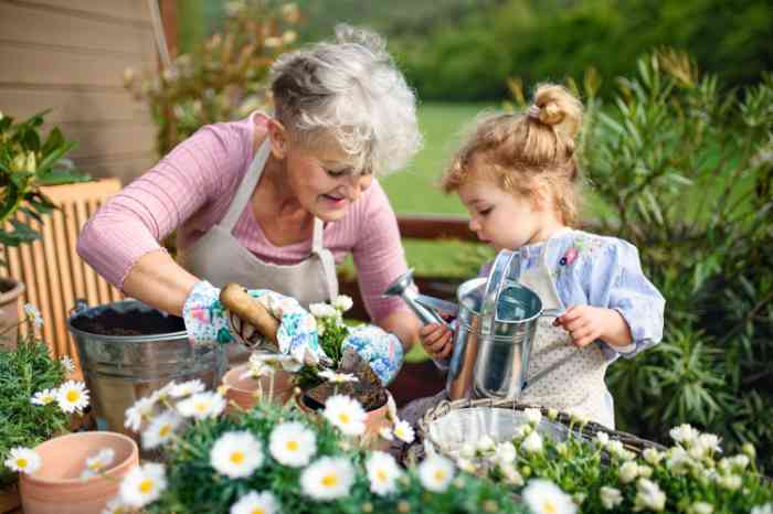 Woman planting flowers with child