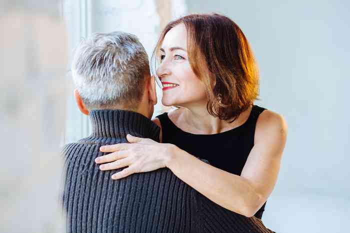 Woman whispering in a man's ear
