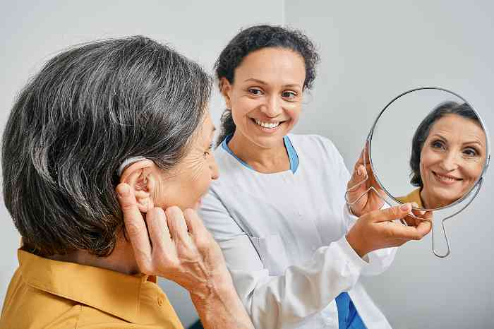 patient trying on hearing aids