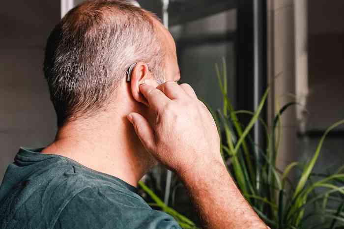 Profile of a man with a flat BTE hearing aid
