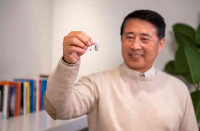 A man showing hearing aid