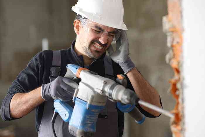 A man using a power drill