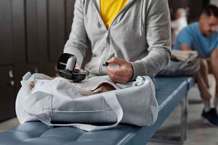Man turning hearing aids on