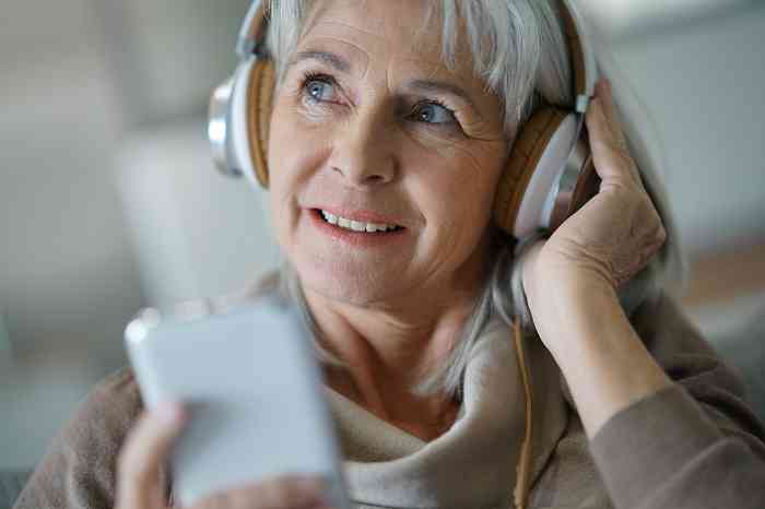 Old woman wearing headphones