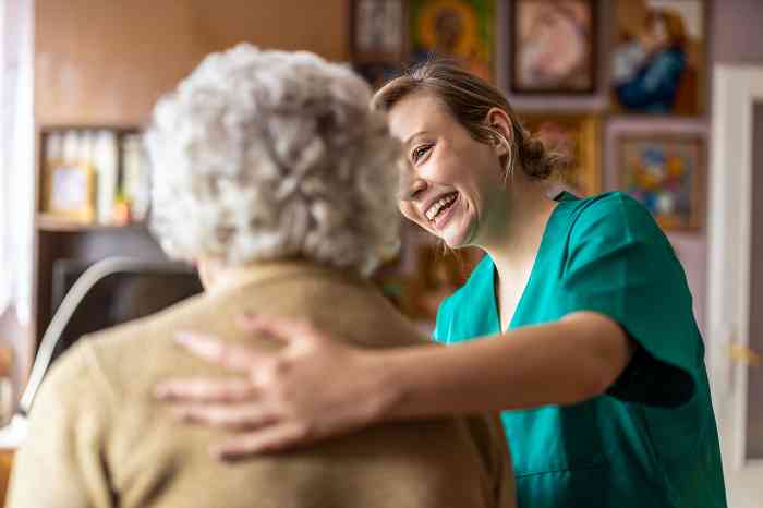 A specialist helps an elderly woman into her appointment