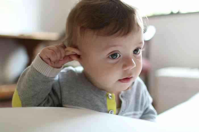 Baby touching the ear