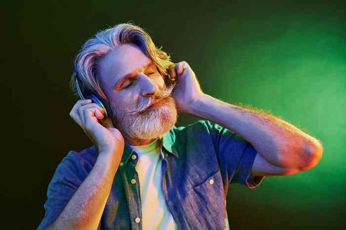 A man on a colorful background wearing headphones