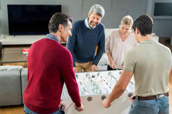client caregiver playing foosball