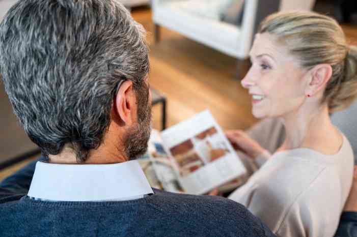 male cliente female caregiver reading book 