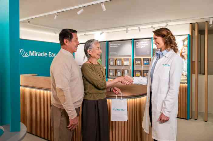 asian couple handshake female audiologist