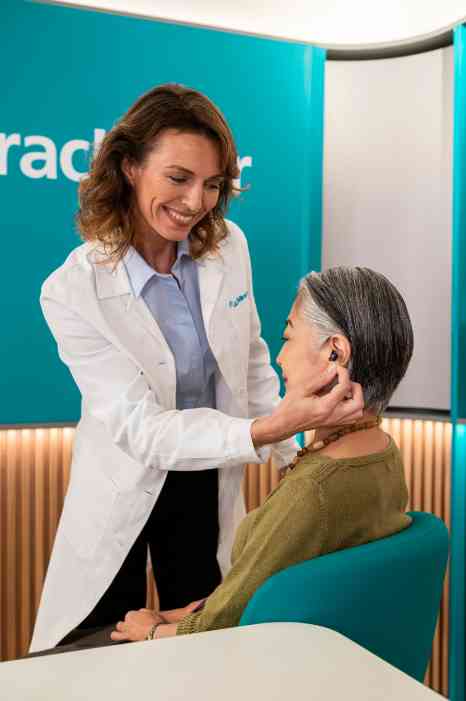 female audiologist and female customer in store