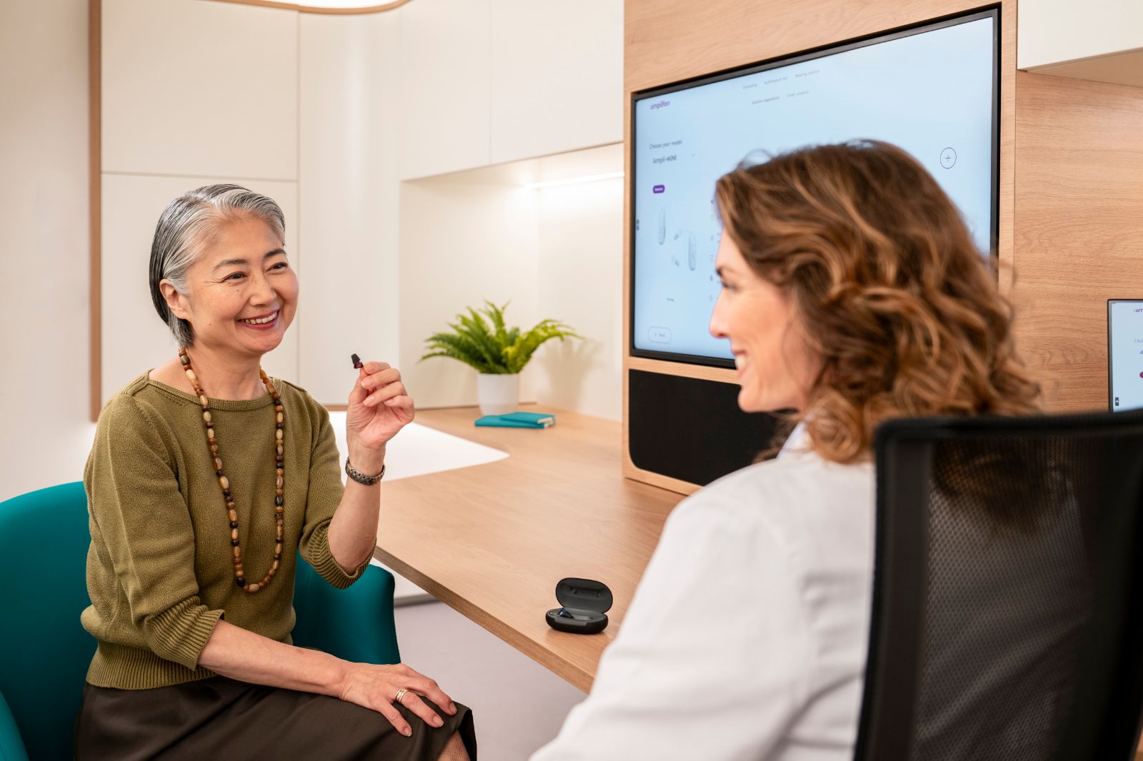 Audiologist and patient during a hearing aid consultation