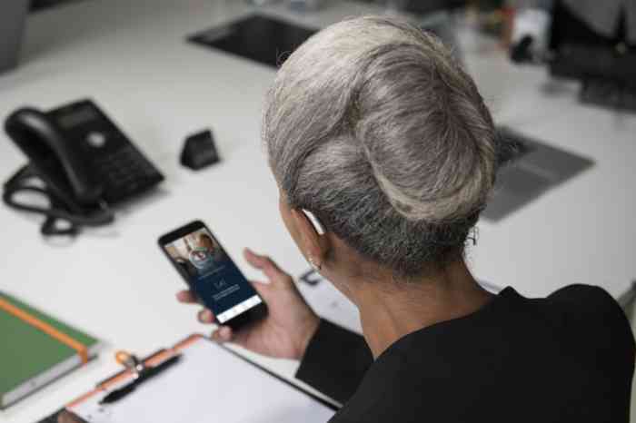 Woman using Miracle-Ear hearing aid app