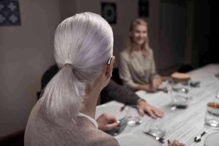 Woman wearing hearing aids while at dinner