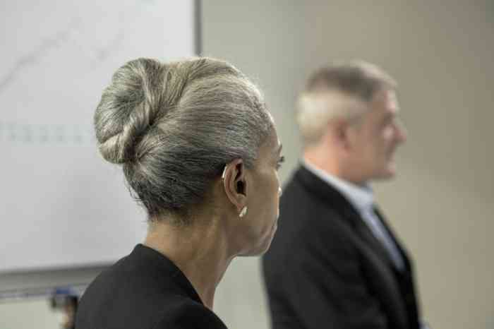 Woman in a business wearing a hearing aid