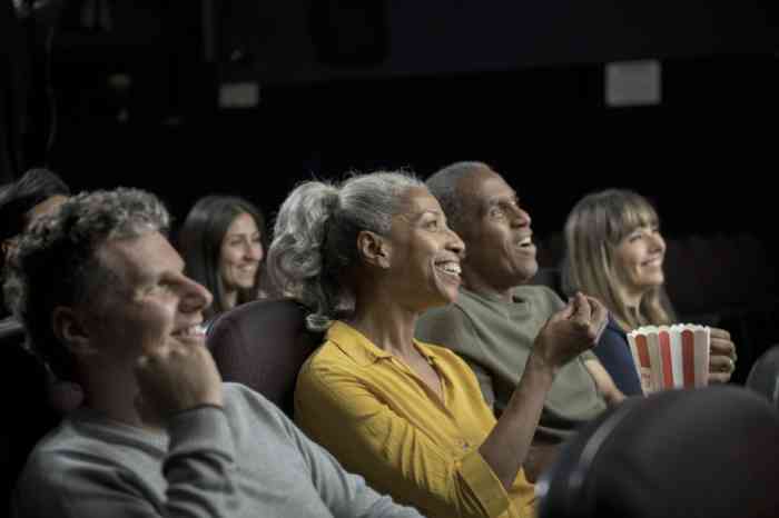 Couple eating pop corns watching a movie at the cinema