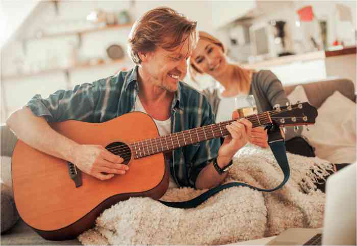 Couple playing guitar together