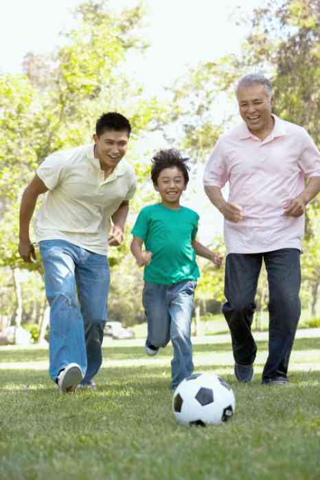Family members playing soccer in the garden