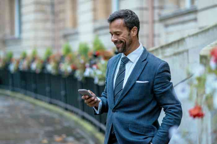 Man wearing a hearing aid with dog and granddaughter