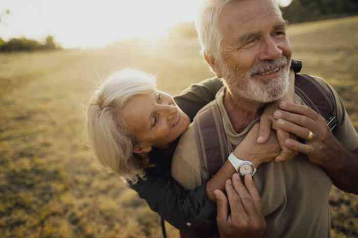 Elderly couple hugging in the sunset