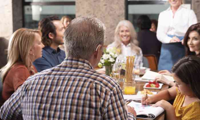 Man wearing hearing aids at restaurant