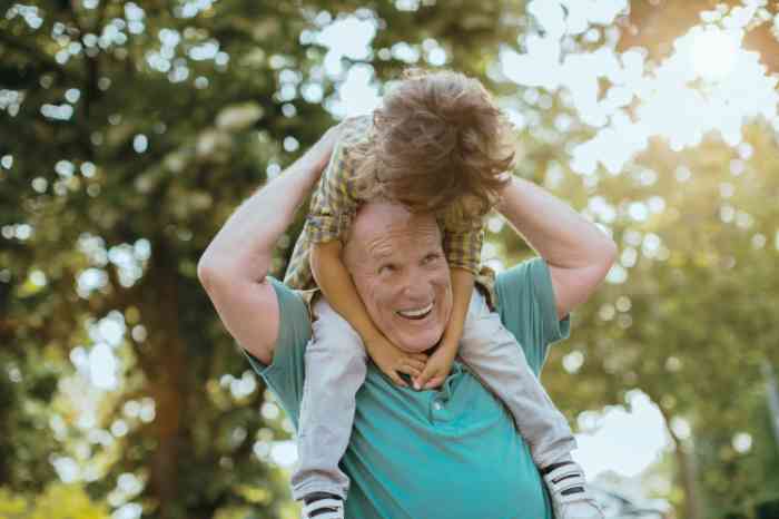 Playful grandfather playing with his grandson outdoors