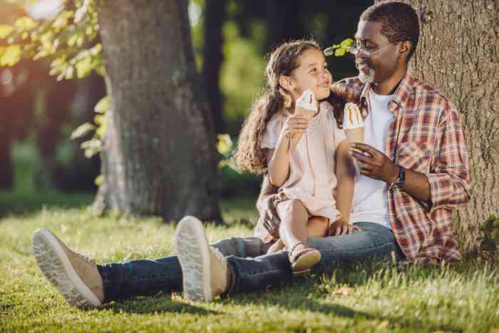 Grandfather and granddaughter having ice cream