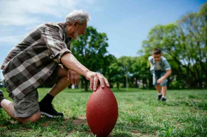 man playing football with grandson