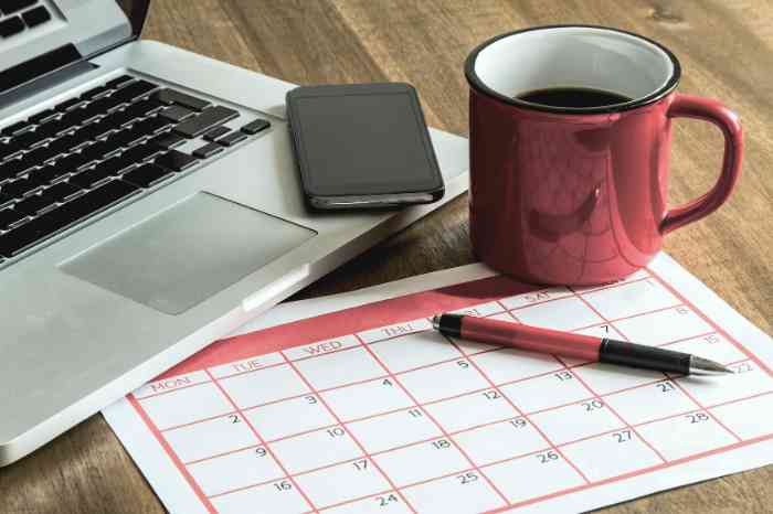 A cup of tea, a laptop, a pen and a smartphone