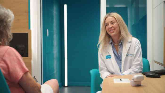 Female hearing care professional smiling at customer in store