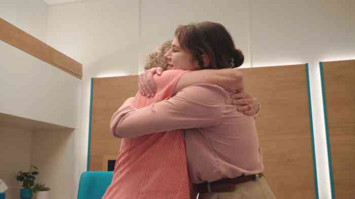 Family members hugging during a Miracle-Ear hearing test