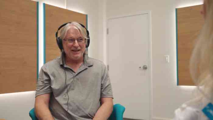 A man undergoing a hearing test at a Miracle-Ear store