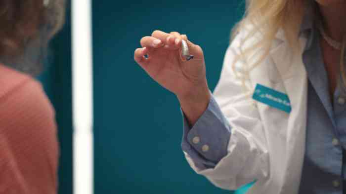 HCP holding up RIC hearing aid