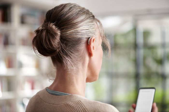 woman on phone wearing hearing aids
